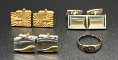 five pairs of cuff watches and a ring on a table