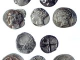 six ancient roman coins are shown in a row on a white surface