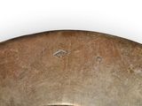 a metal bowl with a handle on a white surface