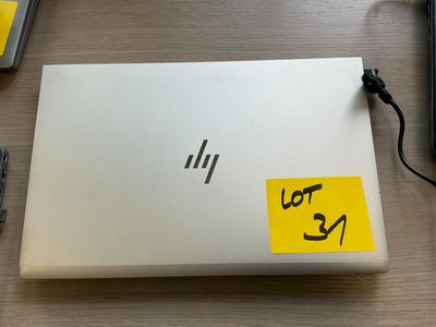 a laptop with a sticker on it sitting on a desk