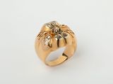 an image of a gold ring with a flower on it
