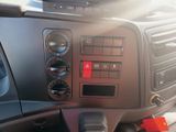 a close up of a car dashboard with a red button