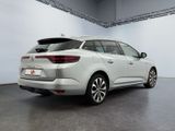 the rear end of a white car parked in a garage