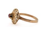 an image of a gold ring with a purple stone