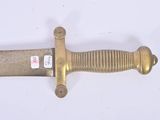 a gold colored sword on a white surface