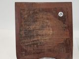 a clock that is sitting on a wooden stand