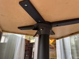 a close up of a ceiling fan on a patio
