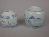pair of blue and white vases sitting on top of a table