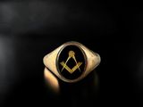 a close up of a ring with a masonic symbol on it