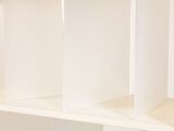 a white book shelf with a bunch of books on top of it