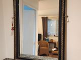 a mirror sitting on a dresser in a room
