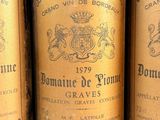three bottles of wine sitting on top of a wooden table
