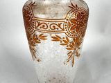 a glass vase with a brown and white design on it