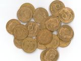 a lot of coins that are on a white surface