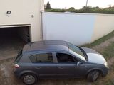 a small car parked in front of a garage