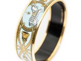 a close up of a ring with a gold and blue design on it