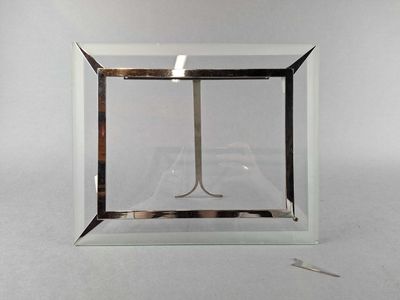 a glass box with a pair of scissors inside of it
