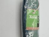a green towel wrapped in plastic on a white surface