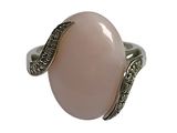 a close up of a ring with a pink stone on it