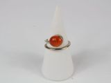 an image of a ring with an orange stone on it