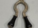 pair of black and silver metal handles on a white surface