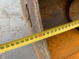 a measuring tape that is on the side of a piece of metal