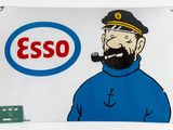 a sign that says esso with a man smoking a pipe