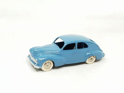 a blue toy car that is sitting on a white surface