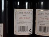 three bottles of wine are on a shelf in a store