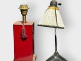 pair of antique lamps on stands with a red base and a white shade