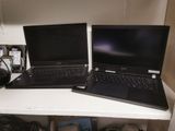 two laptops sitting on top of a white desk
