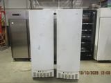 two refrigerators that are sitting in a room