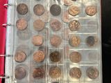 an open book with a bunch of coins in it sitting on a table