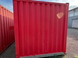 two red shipping containers sitting in a lot next to each other