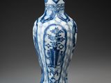 blue and white vase with a design of flowers and birds
