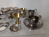 a table with a lot of silver items on it