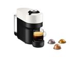 un gros plan d'une machine à café avec une tasse de café à côté