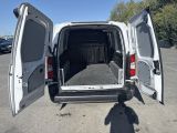 a white van with its doors open in a parking lot