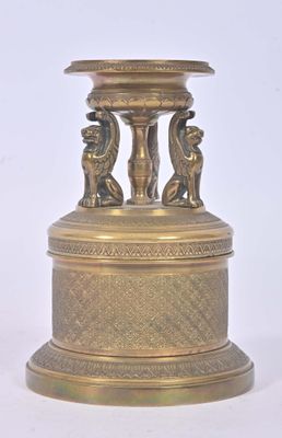 un vase en or surmonté de deux oiseaux