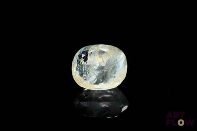 a close up of a blue and white diamond on a black surface