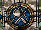a stained glass window with a picture of a baseball bat and a bat