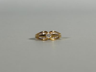 a close up of a gold ring with two diamonds on it