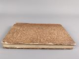 an old book with a brown cover sitting on top of a table