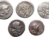 four ancient roman coins, one of which is a woman and one of which is a man