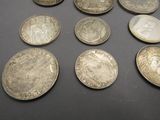 some coins are sitting on a table with a black surface