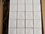 a close up of a box of white tiles on a table