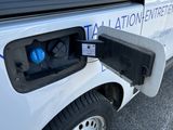 a white van that has a blue light on the side of it