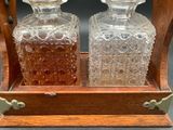 two bottles that are sitting on a wooden stand