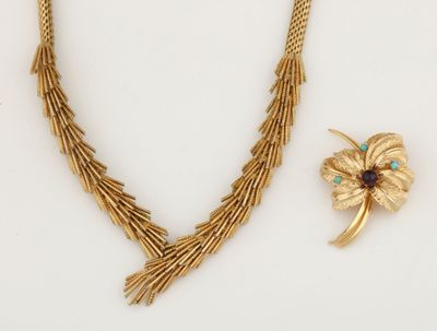 two pieces of jewelry including a necklace, broochle and a broochle