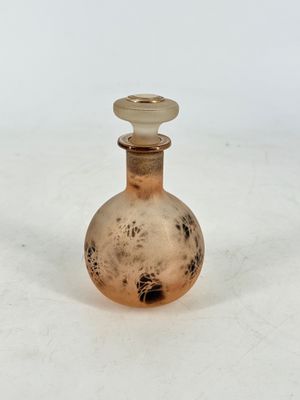 a small glass bottle that is sitting on a table